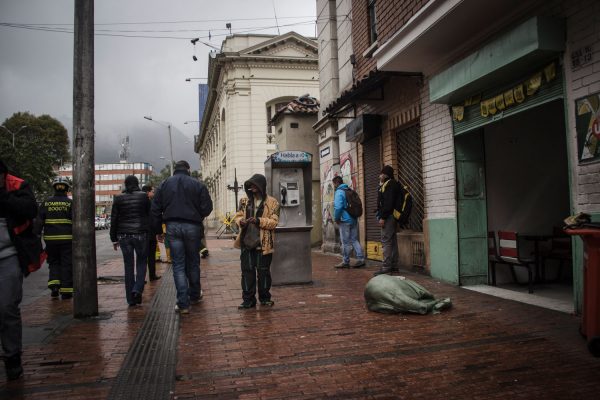 people standing on dirty street