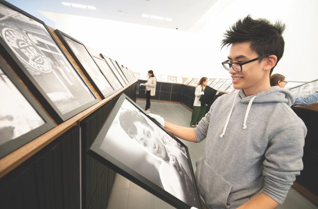 A student admires a framed photograph
